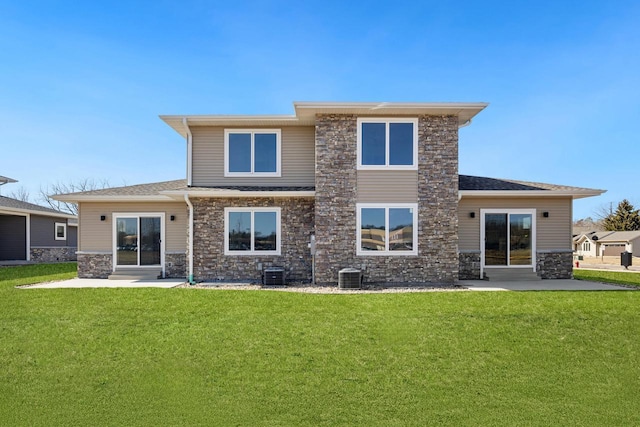 back of house with a patio, a lawn, and stone siding