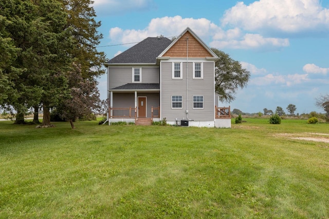 rear view of house featuring a lawn