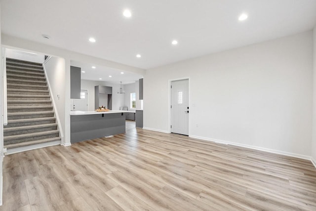 unfurnished living room featuring light wood-type flooring