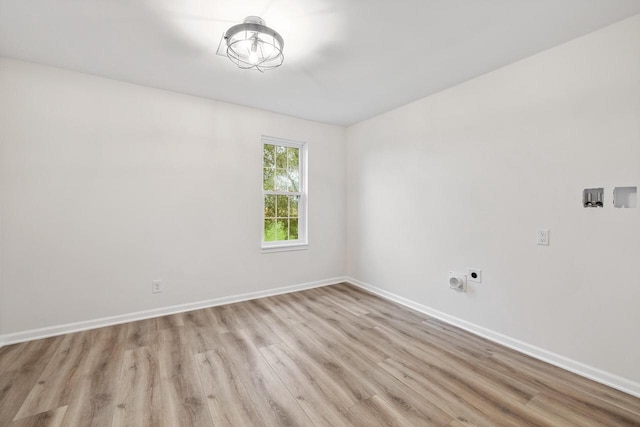 spare room with light hardwood / wood-style flooring