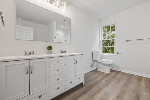 bathroom featuring hardwood / wood-style floors, vanity, and toilet