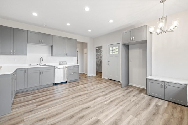 kitchen with stainless steel dishwasher, sink, light hardwood / wood-style flooring, and gray cabinets