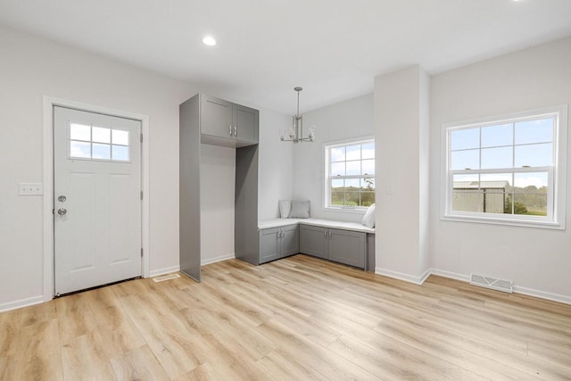 foyer with a notable chandelier and light hardwood / wood-style flooring