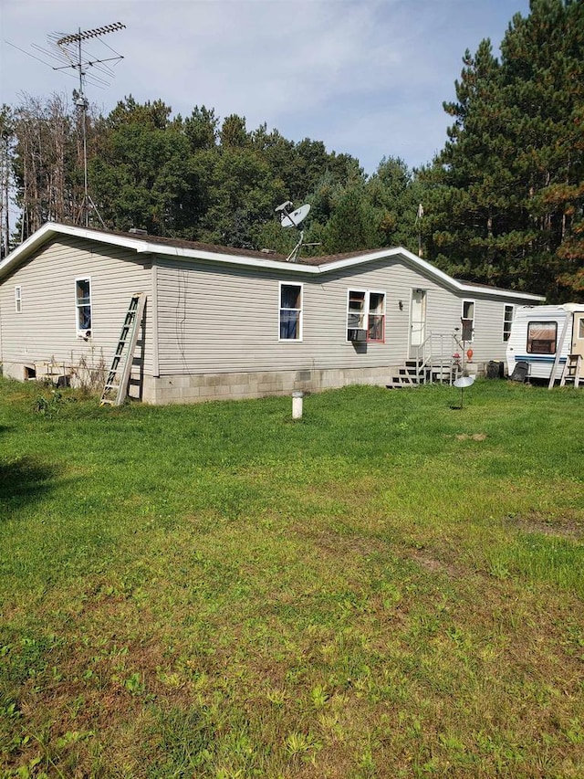 back of property featuring a lawn