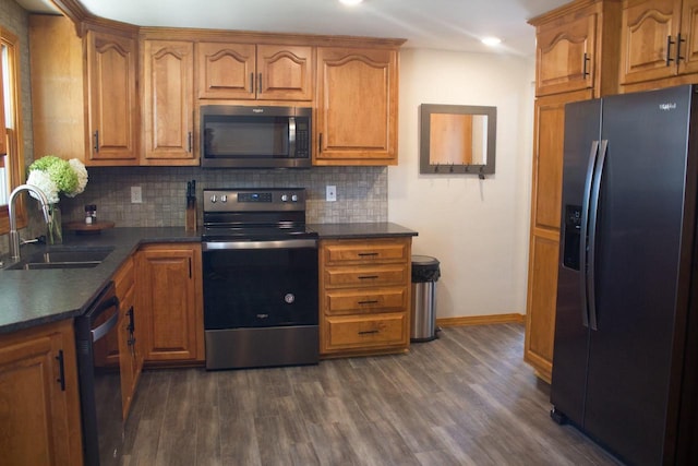 kitchen featuring dark hardwood / wood-style flooring, stainless steel appliances, tasteful backsplash, and sink