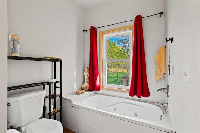 bathroom with a tub and toilet