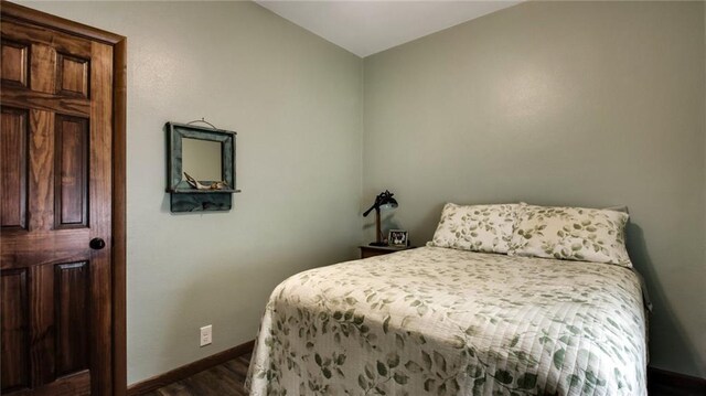 807 Miner Ave, Ladysmith, WI 54848 - bedroom with baseboards and dark wood finished floors