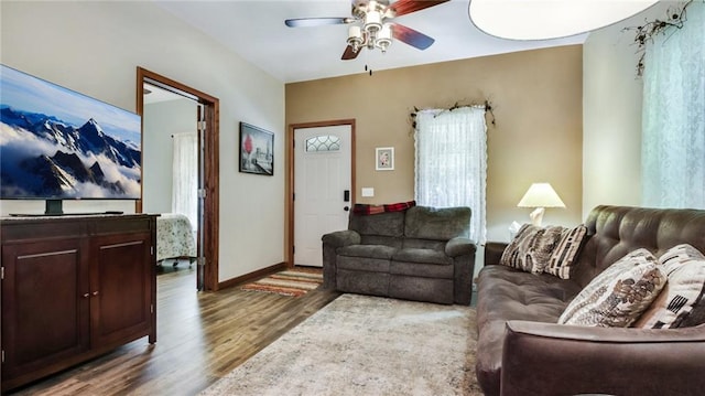 living room featuring ceiling fan and hardwood / wood-style flooring