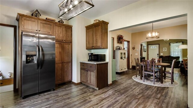 807 Miner Ave, Ladysmith, WI 54848 - kitchen with baseboards, arched walkways, dark wood-type flooring, hanging light fixtures, and stainless steel fridge with ice dispenser