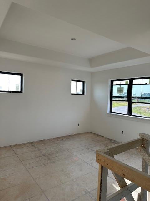 spare room with a tray ceiling