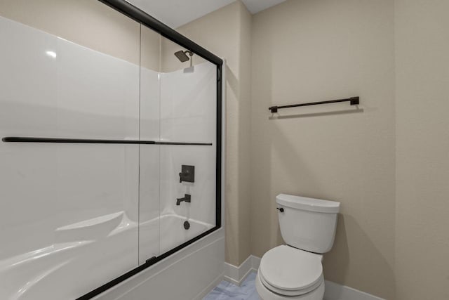 bathroom with enclosed tub / shower combo and toilet