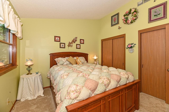 bedroom with light carpet, a closet, and a textured ceiling