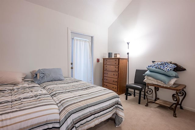 carpeted bedroom featuring lofted ceiling