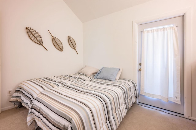 carpeted bedroom featuring lofted ceiling