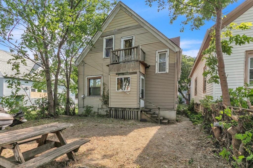 back of property with a balcony