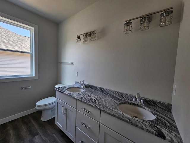 bathroom featuring vanity, hardwood / wood-style floors, and toilet