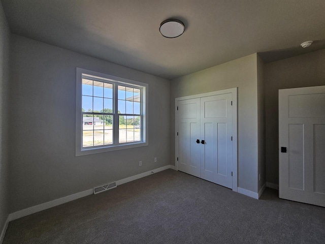 unfurnished bedroom featuring a closet and carpet