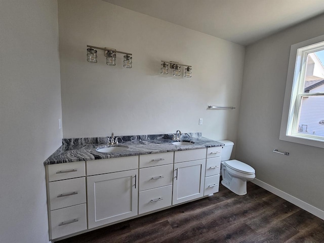 bathroom with hardwood / wood-style floors, vanity, and toilet