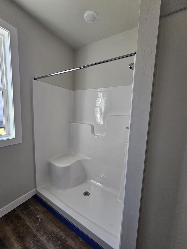 bathroom featuring a shower and hardwood / wood-style flooring