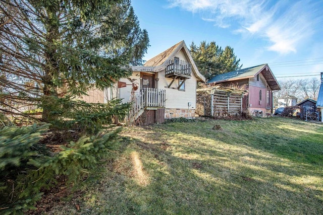 rear view of house with a yard