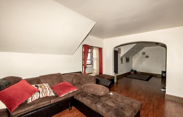 living room with lofted ceiling and dark hardwood / wood-style floors