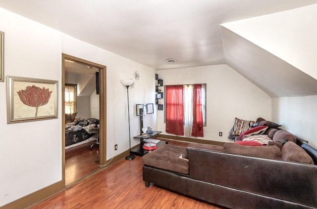 bedroom with lofted ceiling and hardwood / wood-style floors