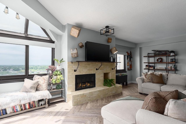 living room featuring light parquet flooring, a textured ceiling, and a brick fireplace