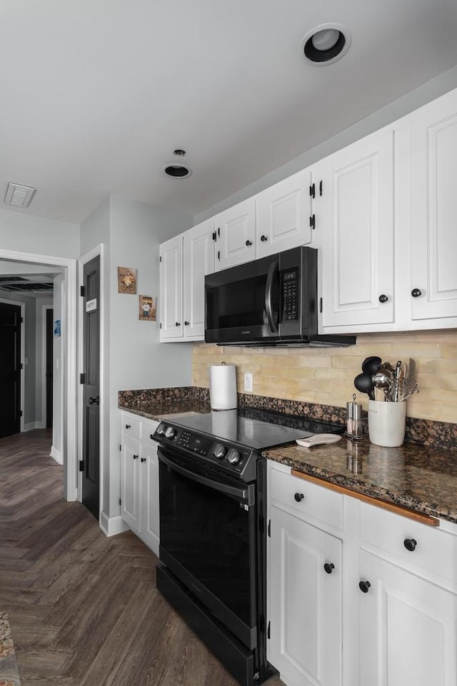 kitchen featuring decorative backsplash, dark stone countertops, white cabinets, dark hardwood / wood-style flooring, and black appliances