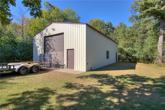 view of outbuilding featuring a yard and a garage