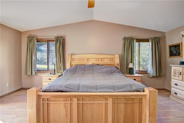 bedroom with light wood-type flooring, lofted ceiling, and ceiling fan