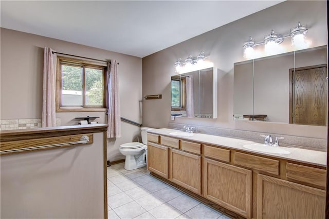 bathroom featuring tile patterned flooring, vanity, and toilet