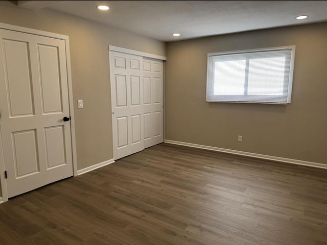 unfurnished bedroom featuring dark hardwood / wood-style flooring