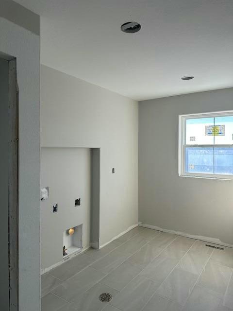 laundry area with laundry area and baseboards