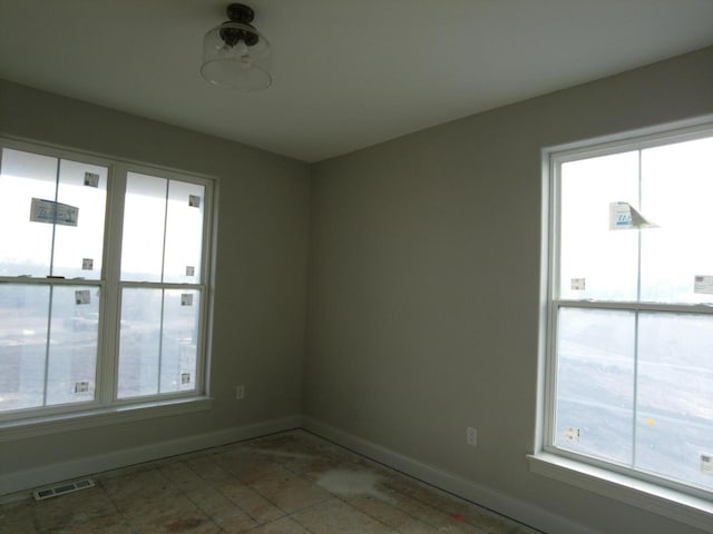 empty room with visible vents and baseboards