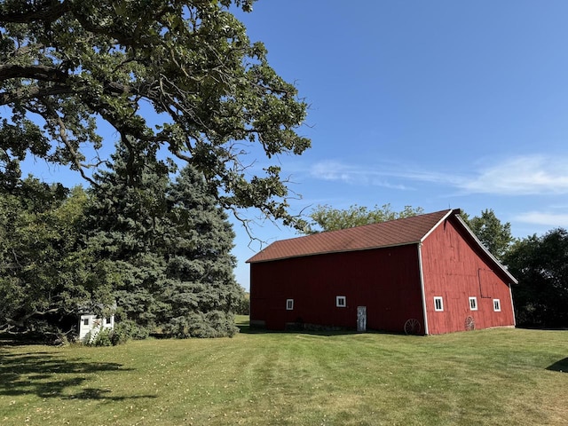 view of outbuilding with a lawn