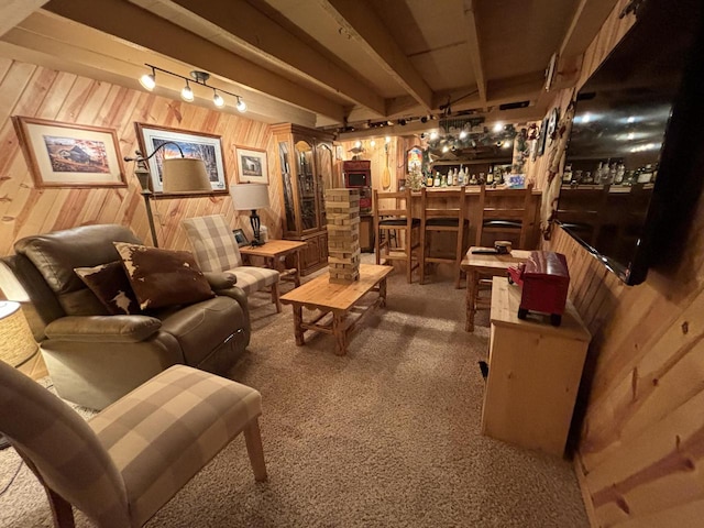 interior space with carpet flooring, beamed ceiling, wooden walls, and indoor bar