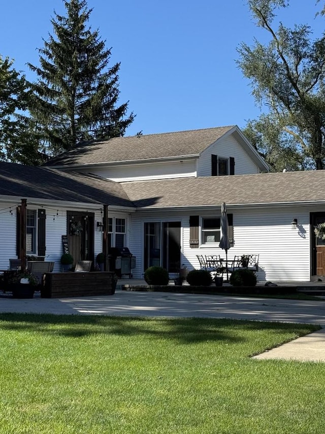 rear view of property with a yard