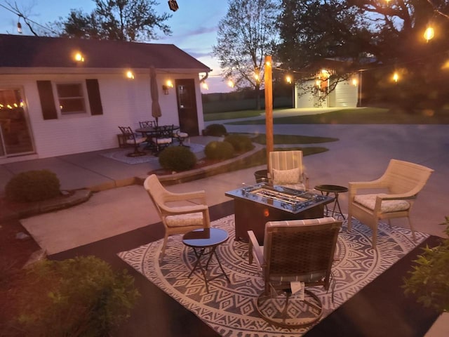 patio terrace at dusk with an outdoor fire pit