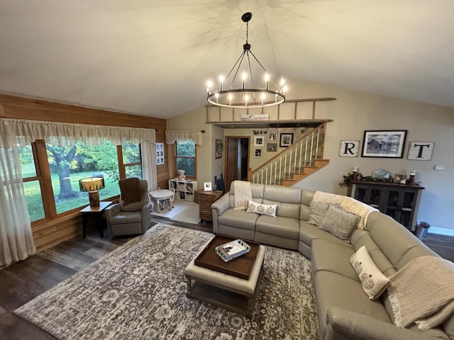 living room featuring lofted ceiling, dark wood-type flooring, and an inviting chandelier