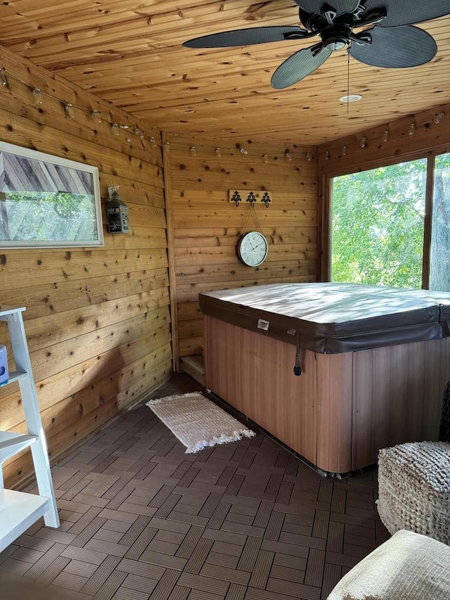 miscellaneous room featuring a jacuzzi, wood walls, wooden ceiling, and ceiling fan