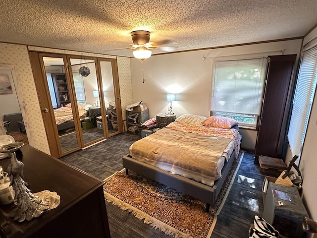 bedroom featuring ceiling fan, a textured ceiling, crown molding, and french doors