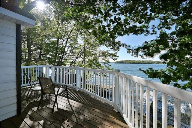 wooden deck featuring a water view