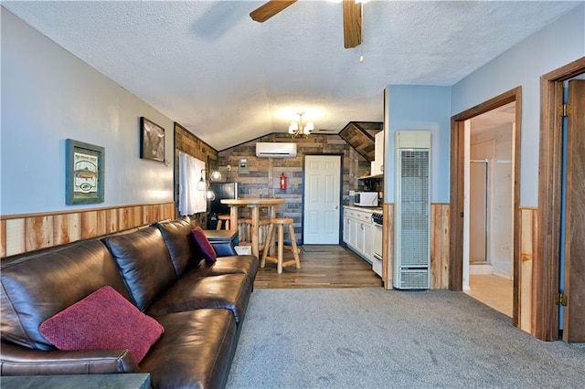 living room featuring a textured ceiling, wooden walls, ceiling fan, and a wall mounted air conditioner