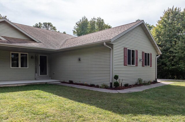 view of side of property with a yard