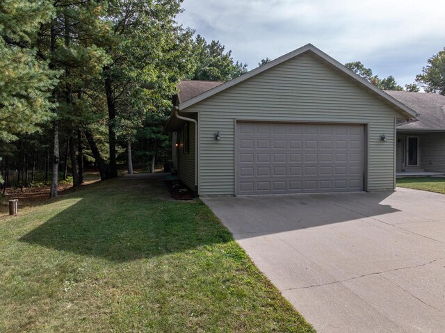 view of property exterior with a yard and a garage