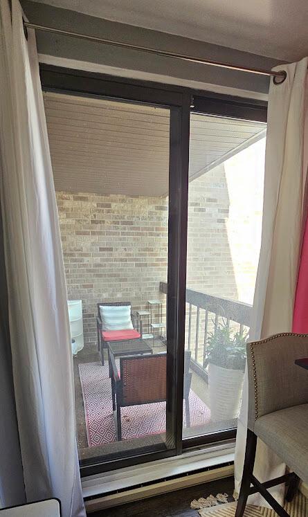 entryway featuring brick wall