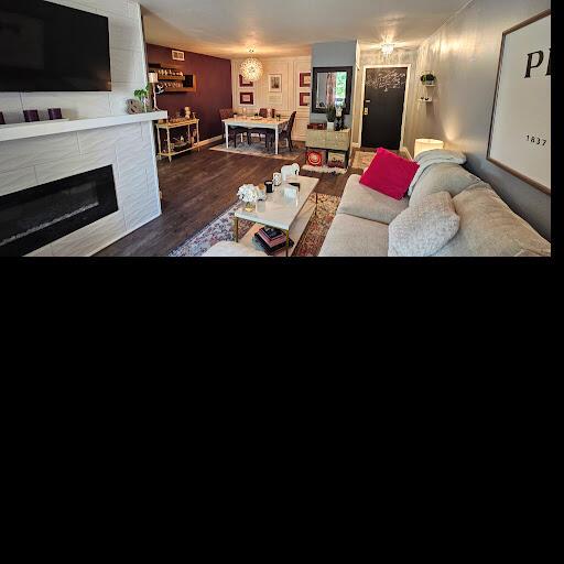 living room featuring a fireplace and dark wood-type flooring