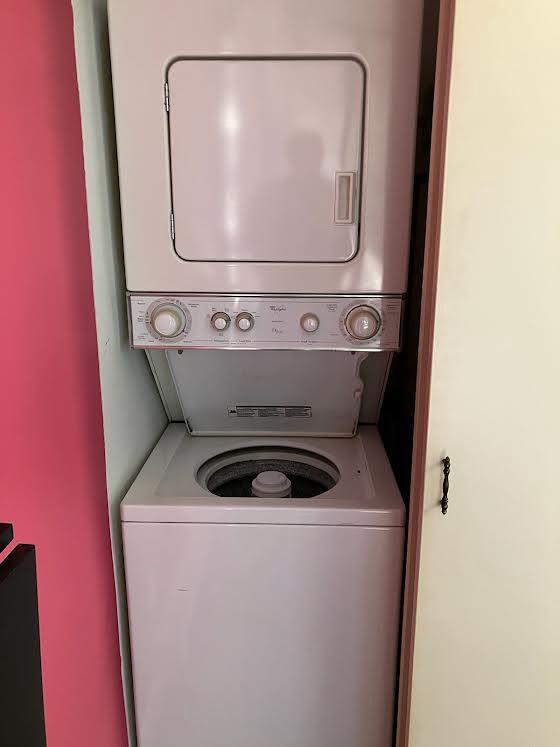 clothes washing area with stacked washer / drying machine