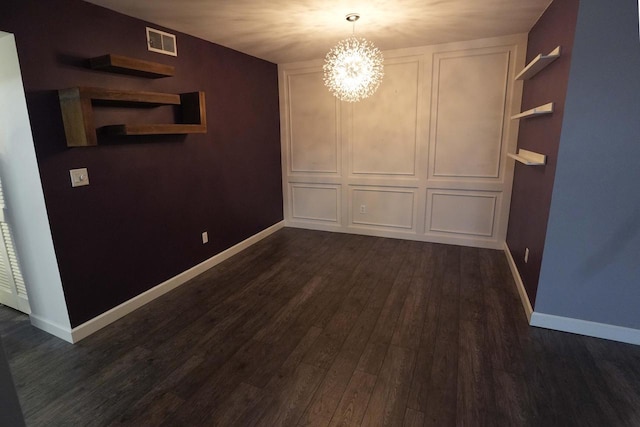 unfurnished dining area with dark wood-type flooring and a chandelier