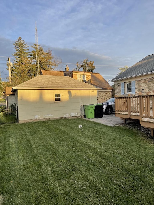 back of house with a deck, a yard, and a patio area